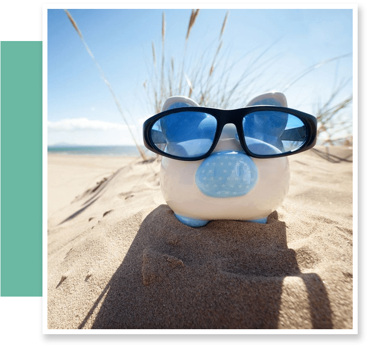 A piggy bank with sunglasses on the beach.